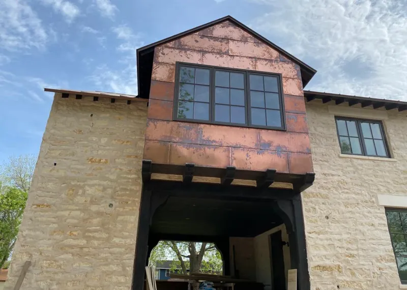 Copper metal panel facade on a stone building for Roof Repair in Kansas City